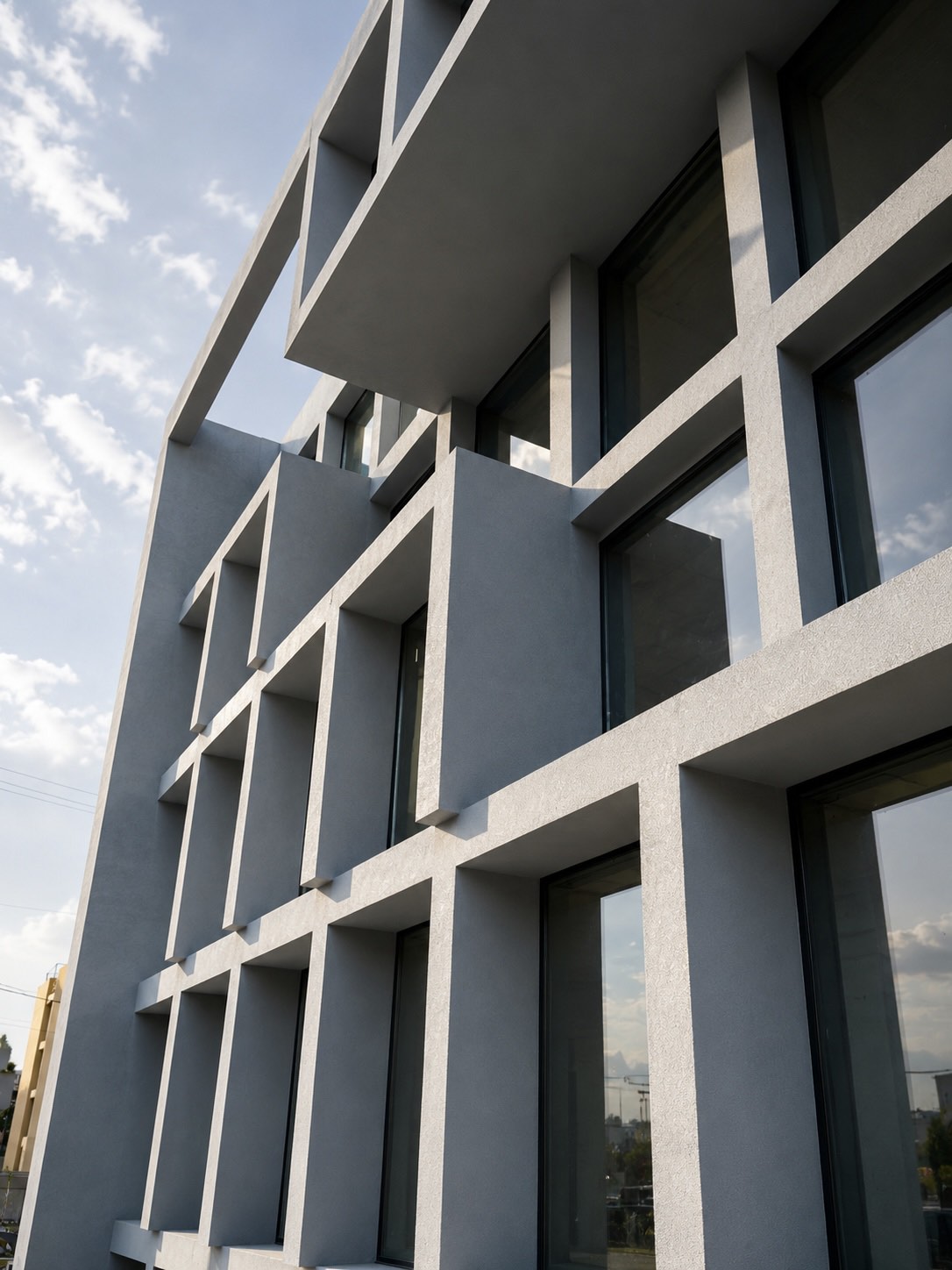 Commercial building with high-performance aluminium glazing and minimal window systems by Mparolas Aluminium Systems.
