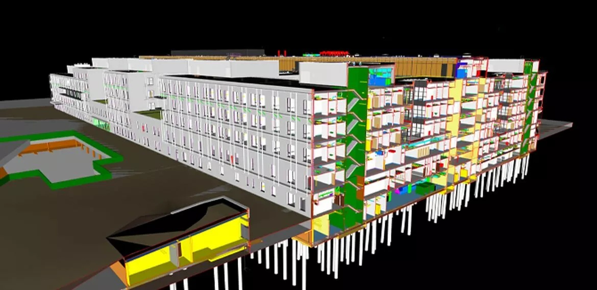 Architects observing modern glass façade building with Reynaers Aluminium systems.