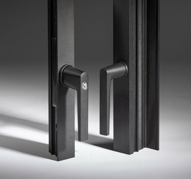Reynaers Touch black door handles with minimalist design mounted on slim aluminium door profiles