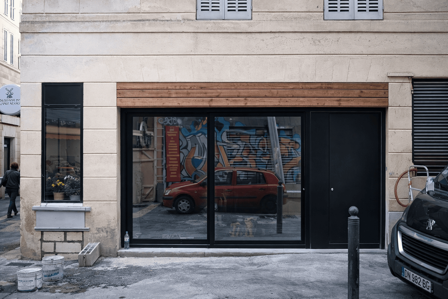 Completed black aluminium storefront windows at commercial project in Marseille France