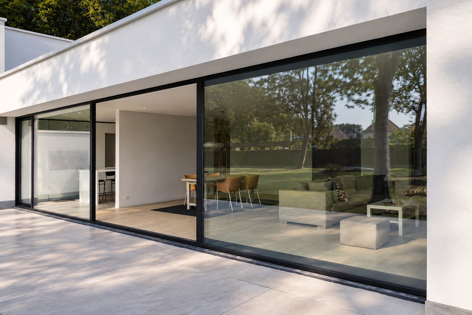 Reynaers ConceptPatio 130 lift and slide aluminium doors with large glazed panels and slim dark frames in a modern residence